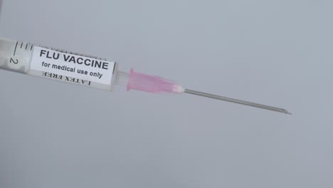 Hand-With-Syringe-To-Administer-Flu-Vaccine---close-up