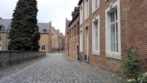 Walking-in-the-beguinage-of-Leuven,-Belgium