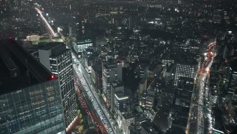 Night-Traffic-On-The-Road-In-Shibuya,-Tokyo,-Japan---high-angle,-hyperlapse