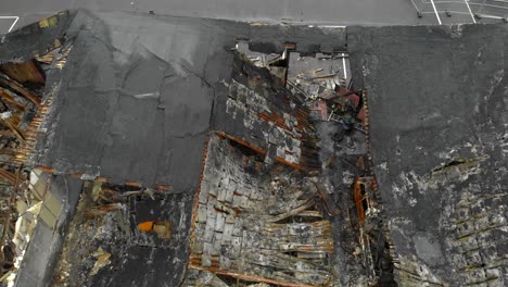 Aerial-view-of-destroyed-building-with-pieces-of-roof-remaining-after-fire