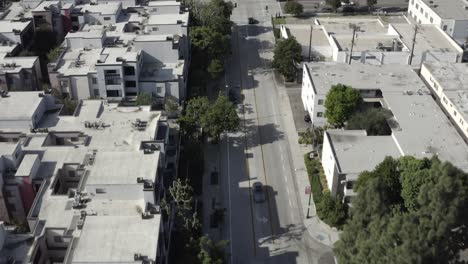 Downtown-Burbank-urban-block-buildings-rooftops-traffic-intersection-aerial-birdseye-view-down-sunny-street