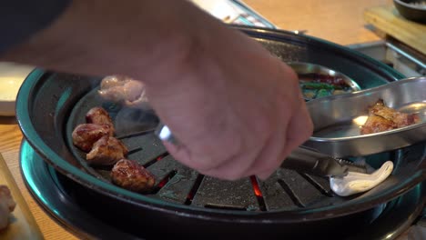 Pork-Belly-Being-Grilled-On-Charcoal-Griller-In-Korean-Restaurant
