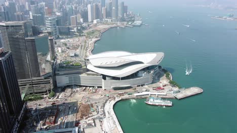 Hong-Kong-famous-Convention-and-Exhibition-Centre-building-in-Victoria-harbour,-Top-down-aerial-view