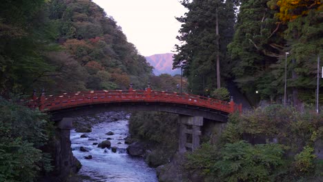 Calm-view-of-Shinkyo-Bridge-in-Nikko-with-river-running-below-it-with-cars-passing-by