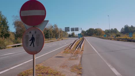 No-pedestrians-and-no-entry-road-sign-on-empty-road,-outside-static-view
