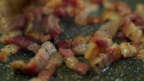 Chef-is-mixing-some-diced-pancetta-with-a-wooden-spoon