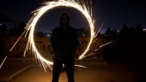 fire-ring-behind-man-light-painting-with-fire-works