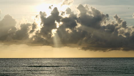 Beautiful-natural-view-of-rays-of-light-through-the-clouds-on-a-sunset-in-Florida-beach-overlooking-the-horizon-and-the-sea