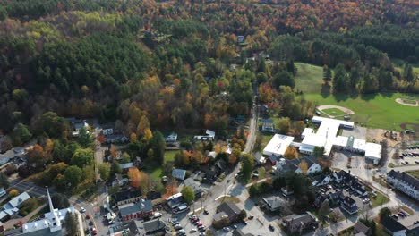 Aerial-View-of-Stowe,-Vermont-USA-City-Under-Mount-Mansfield-Ski-Resort-on-Sunny-Autumn-Day,-Tilt-Up-Drone-Shot