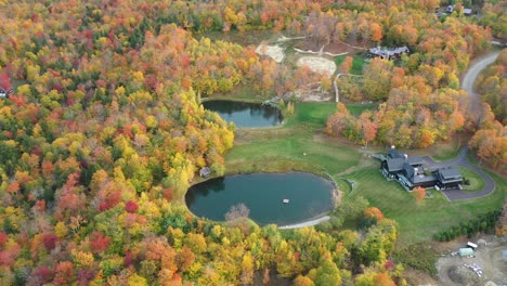 Aerial-View-of-Colorful-Forest,-Ranch-Ponds-and-Mansion-in-American-Countryside
