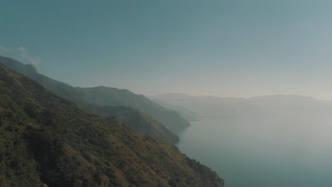 Drone-aerial-shot-of-lake-Atitlan-and-the-mountains-during-a-cloudy-morning-in-Guatemala