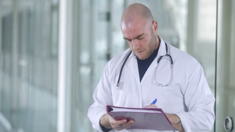 Un-Médico-Masculino-Atractivo-Está-Tomando-Notas-En-Un-Centro-Médico