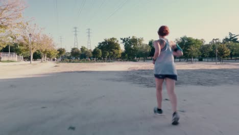 A-shot-following-a-female-runner-in-a-park