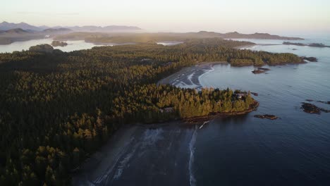 Drone-Aerial-View-of-Amazing-Landscape-and-Shoreline-of-Vancouver-Island,-Canada-on-Sunset-Sunlight-With-Mist-in-Skyline