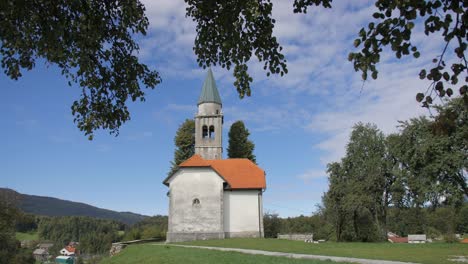 Old-church-in-Slovenia-countryside-on-sunny-summer-day-wide-left-pan