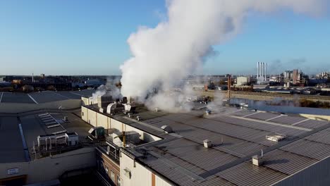 Pull-away-from-smoke-bellowing-from-warehouse-with-horizon-setting