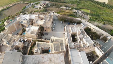 4k,-aerial-drone-footage,-flying-over-the-fortified-stone-wall-city-of-Mdina-and-tilt-revealing-the-surrounding-countryside-landscape-of-the-Northern-Region-of-Malta