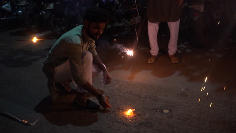Diwali-celebration-with-fireworks-firecrackers-fulbaja-fatake-in-India-Mumbai-banned-2020-man-lighting-up-chakri