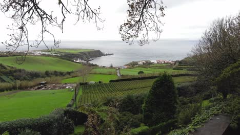 Reveal-of-beautiful-coastal-village-on-Atlantic-Ocean-shore,-Sao-Miguel-Island-,-Azores