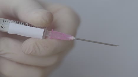 Nurse-Squeezes-The-Plunger-Of-A-Syringe-Filled-With-Vaccine,-Close-Up-Shot