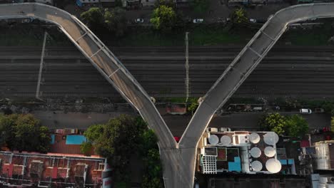 Top-down-look-at-a-v-shaped-bridge-for-pedestrians-in-T-Nagar,-Chennai-city-India,-some-people-walking,-some-cycling-over-it
