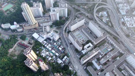Downtown-Hong-Kong-daily-traffic-surrounded-with-city-skyscrapers,-Aerial-view