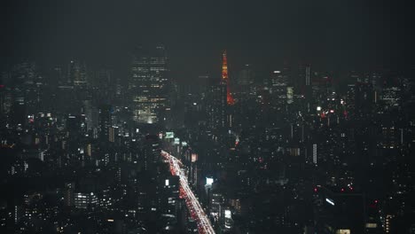 Fog-Over-Tokyo-Skyline-With-Distant-View-Of-Tokyo-Tower-At-Night---high-angle,-hyper-lapse
