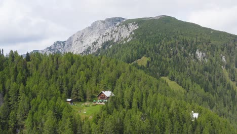 Aerial-View-Of-Dom-Na-Peci-Mountain-Hut-At-Koroska-Nestled-By-Forests