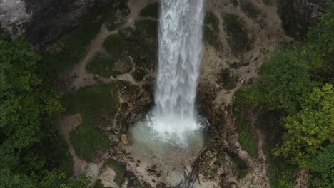 Wildenstein-Waterfall-splashing-base-in-the-southern-Austrian-Alps-,-Aerial-pedestal-up-reveal-shot