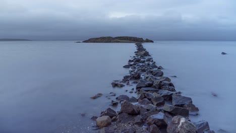 Dramatic-time-lapse-video-of-rocky-path-leading-to-an-island