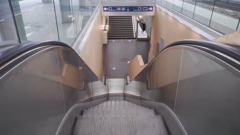 Moving-escalator-at-empty-railway-station-during-the-COVID-19-lockdown,-Leuven,-Belgium