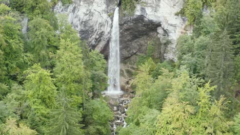 Wildenstein-Waterfall-in-southern-Austria-falling-over-54m-over-the-cliff,-Aerial-dolly-out-reveal-shot