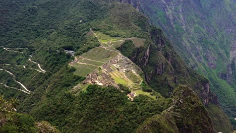 Aerial-Drone-Pan-Of-Machu-Picchu-At-Huayna-Pichu-mountain-peak,-Peru