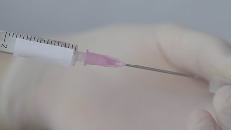 Medical-Syringe-Uncapped-By-Hand-Wearing-White-Gloves,-Close-Up-Shot