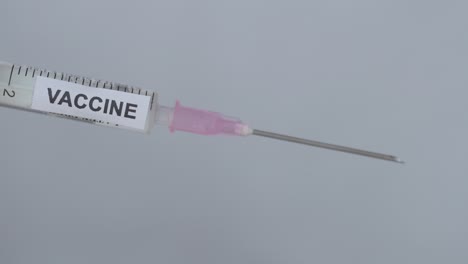 Removing-Cap-Of-Syringe-Needle---Covid-19-Vaccine---close-up