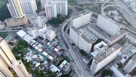 Downtown-Hong-Kong-daily-traffic-surrounded-with-city-skyscrapers,-Aerial-view