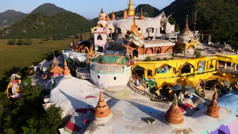 Monks-go-upstairs-in-a-Big-temple---Brightly-colored-Wat-Simalai-Song-Tham-on-top-of-the-hill-among-mountains