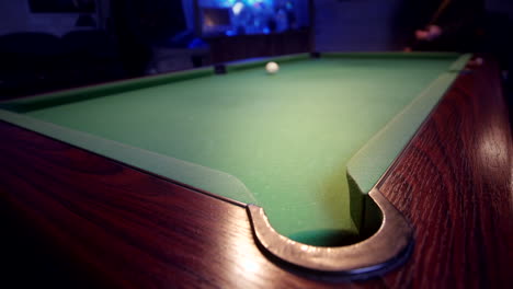 The-eight-ball-is-potted-on-a-green-pool-table