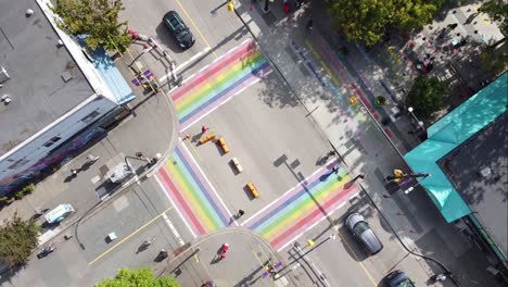 2-3-aerial-twist-panaramic-birds-eye-view-above-Davie-and-Bute-rainbow-sidewalks-in-downtown-Vancouver's-Gay-Village-Coimmunity-on-sunny-afternoon-with-COVID-19-barriers-on-streets-with-light-traffic