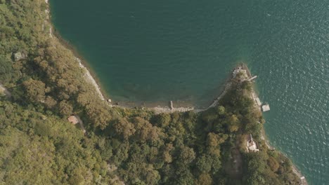 Drone-aerial-top-perspective-of-waves-crashing-on-the-shores-of-Lake-Atitlan,-Guatemala
