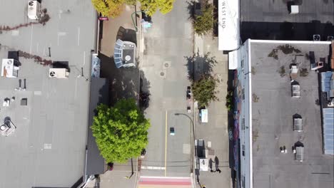 aerial-birds-eye-view-fly-over-downtown-Vancouver-Gay-Pride-Village-the-West-End-where-iconic-LGBTQ-flag-paved-on-intersection-of-Davie-and-Bute-on-a-sunny-afternoon-with-modern-portable-bathroom-2-4