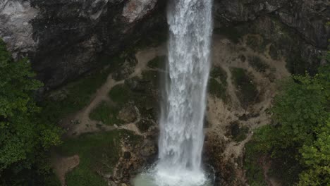 Wildenstein-Waterfall-rocky-eroded-base-in-the-southern-Austrian-Alps,-Aerial-hovering-shot