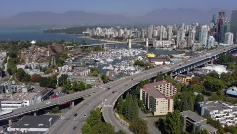 3-4-Aerial-panout-over-Upper-Granville-Island-residential-commercial-community-and-bridge-leading-downtown-over-the-False-Creek-yacht-parked-boating-clubs-on-a-lush-summer-lockdown-pandemic-afternoon