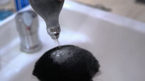 Close-up-of-a-barber-applying-talc-powder-to-a-neck-duster,-brush
