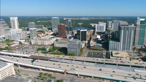 Aerial-view-following-I-4-traffic-along-the-Downtown-Orlando-skyline