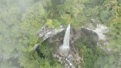 Top-view-of-Wildenstein-Waterfall-in-the-south-Austrian-Alps-with-watery-mist,-Aerial-top-dolly-out-shot