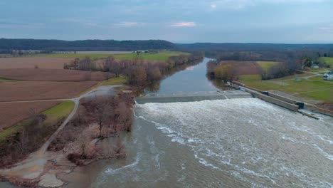 Aerial-dolly-shot-to-the-right-of-dam-and-lock-number-3-in-Kentucky-river-in-the-fall-at-sunset