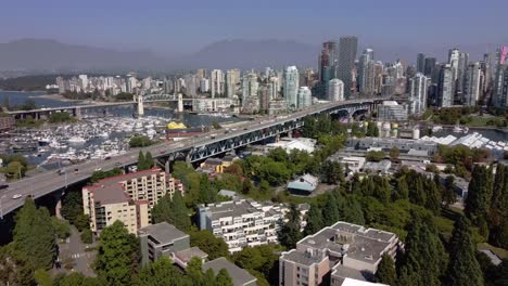1-4-Aerial-panaramic-fly-over-Granville-Island-False-Creek-Residential-commercial-luxury-modern-skyscraper-community-by-the-yacht-clubs-and-the-lush-green-parks-in-downtown-Vancouver-Canada-seaside