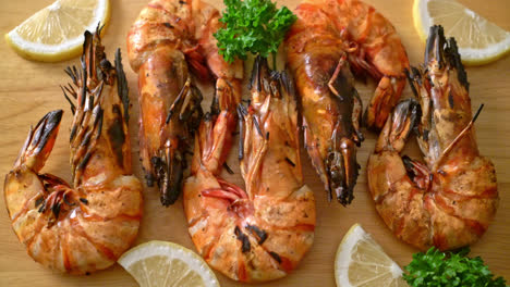 grilled-tiger-prawns-or-shrimps-with-lemon-on-wood-board