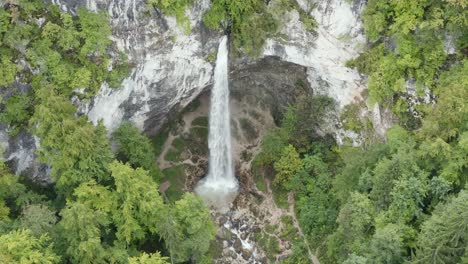 Approaching-to-Wildenstein-Waterfall-in-southern-Austrian-alps-from-high-up,-Aerial-tilt-down-reveal-shot